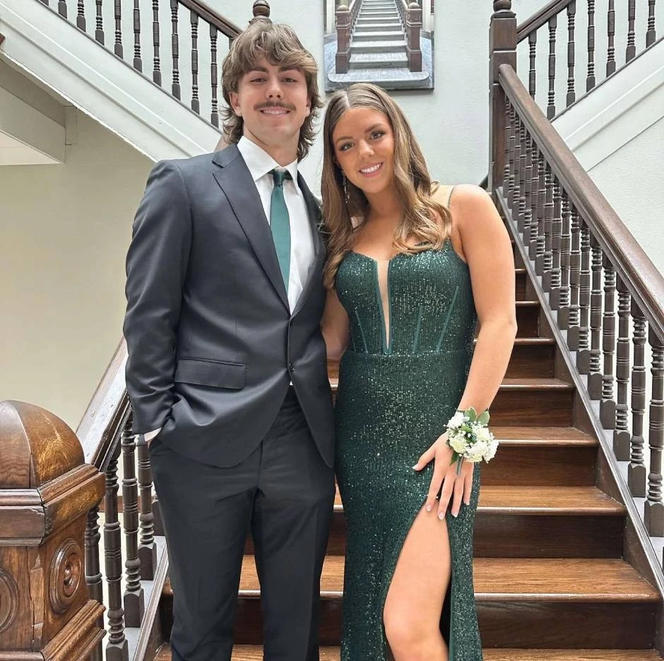 Сouple wearing a green gown and a black suit